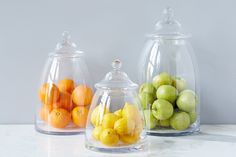 three glass containers filled with different types of fruit