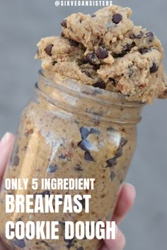 a hand holding a cookie dough in a jar with the words only 5 ingredient breakfast cookie dough