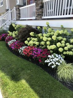 a flower bed in front of a house