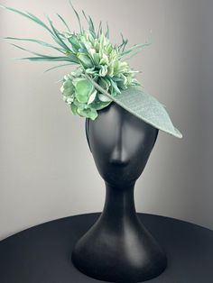 A beautiful pale sage green sinimay base with aqua and blue dahlias accented with hydrangeas and sage green feathers. Sits on a comfortable teal headband. Lightweight and easy to wear. Ships in a high quality storage box. One of a kind.  Perfect for Kentucky Derby, Royal Ascot, church, weddings, just for fun. Pale Sage Green, Fascinator Hats Wedding, Green Fascinator, Green Feathers, Church Weddings, Blue Dahlia, Mother Of Bride Outfits, Derby Fascinator, Blue Hydrangeas