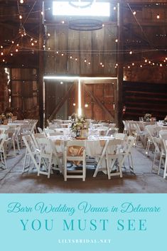 a barn wedding venue with tables and chairs set up for the guests to sit at