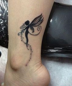 a woman's foot with a small tattoo on the side of her leg and a fairy