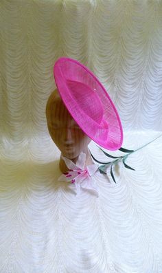 "One contoured saucer with an upturned brim hat sinamay straw fascinator / hat base in fuchsia pink that measures approximately 12\" (30.5 cm) in diameter. The base is contoured to fit against the head. The edges of the brim are finished in sinamay. The multi-layer stiffened sinamay straw has a great sturdy weave and provides excellent support for your millinery creations. This is NOT a finished hat and will not stay on your head unless you add a head band to wear. Add embellishments of your cho Saucer Hat, Hat Form, Millinery Supplies, Hat Base, Fascinator Hat, Diy Hat, Fascinator Hats, Not Ready, Fuchsia Pink