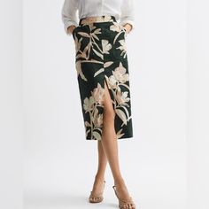 New With Tags! Gorgeous Linen Skirt From Reiss. A Vintage Aesthetic Informs The Jackson Midi Skirt, Thanks To Its Charming Floral Print Design. It’s A High-Rise Style That Skims The Frame For A Figure-Hugging Look. A Front Slip Lends A Sense Of Allure. Tuck In A Collared Blouse For An Office-Ready Edit, Or Choose A Cropped Shape To Take This Look Beyond The Boardroom. Floral Print. High Rise. Dual Patch Pockets. Midi Length. Front Slip. Cotton Lining. Fitted. The Model Is Wearing A Size 8 Measur Elegant Green Floral Print Bottoms, Feminine High-waist Skirt For Work, Feminine High Waist Skirt For Work, Green Midi Length Workwear Bottoms, Elegant Long Skirt With Floral Print, Green Floral Print Bottoms For Work, Chic Floral Print Midi Skirt, Floral Print Knee-length Skirt For Work, Workwear Floral Print Knee-length Skirt