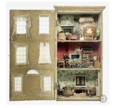 an old doll house with furniture and windows