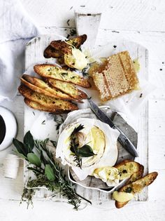 an assortment of bread and cheeses on a tray