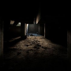 an empty dark room with dirt on the floor