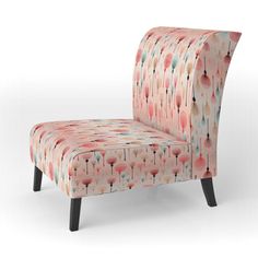 an upholstered pink chair with black legs