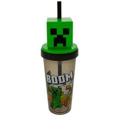 a green cup with an angry face on the lid and a black straw sticking out of it