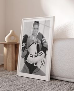 a black and white photo of a woman holding a soccer ball with the word chanel on it