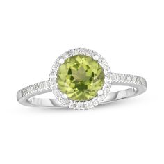 Mix refreshing color and timeless style together when you wear this classic green peridot and diamond frame ring in white gold. Fashioned in 14K white gold This design glistens with a 7.0mm round spring-green peridot center stone. Diamonds line the halo frame and the shank. Peridot is the traditional birthstone for August and is said to bring fame, dignity and protection. This ring shimmers with 1/8 ct. t.w. of diamonds. Available in size 7 only. Frame Ring, Diamond Frame, Green Peridot, Spring Green, Timeless Style, Birthstone, Timeless Fashion, Halo, Diamonds