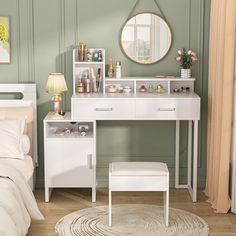 a bedroom with green walls and white furniture