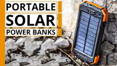 an orange and black solar power bank sitting on top of rocks with the words portable solar power banks