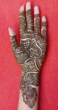 the hand is decorated with henna designs