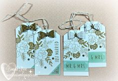 three tags with bows and flowers on them