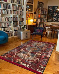 a living room filled with furniture and bookshelves covered in lots of bookcases