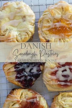 several pastries on a cooling rack with jam in the middle and jelly filling inside