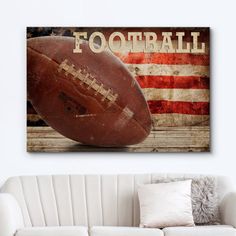 an american flag and football on a wall above a couch