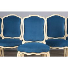 four chairs with blue upholstered back and white trim