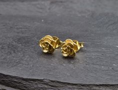 Gold Rose Studs made of Gold Vermeil: 18k Gold over Solid 925 Sterling Silver ☞ made to last. Matching Ring & Matching Pendant - please ask me Details:• Small Flower Earrings• Lever Back Closure - "English Lock"• Dimensions: Length 8mm, Width 8mm• 18k Gold VermeilSKU TE-037 Gold Flower Earrings Studs, Rose Gold Flower-shaped Jewelry With Matching Earrings, 14k Gold Flower-shaped Matching Earrings, Tiny Rose Earring, Small Flower Earrings, Rose Stud Earrings, Floral Studs, Matching Rings, Flower Studs