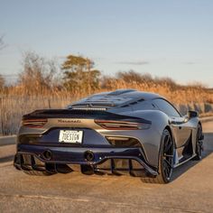 a grey sports car parked on the side of the road