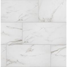 a white marble tile wall with different angles and sizes on the tiles, as well as some