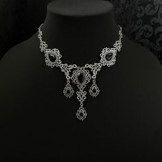 "This romantic necklace features richly detailed antiqued silver filigrees, scrolls and beaded accents. Adorned with sparkling jet black glass crystals, its breath taking design will add Victorian elegance to your outfits. Decorated portion is 8 1/4\" wide and 2 3/4\" tall in the very center.  Necklace length is adjustable with soldered stainless steel cable chain, lobster clasp and extender. If you would like a different length, please send us a message. Matching headpiece and earrings are listed separately in our store. If you don't see items with a color you want, feel free to ask about availability." Gothic Metal Necklace With Intricate Design, Gothic Wedding Necklace With Filigree Detail, Gothic Filigree Necklace For Wedding, Gothic Filigree Wedding Necklace, Gothic Antique Silver Jewelry With Intricate Design, Gothic Metal Jewelry With Filigree, Gothic Filigree Metal Jewelry, Antique Silver Gothic Jewelry With Filigree, Antique Silver Gothic Filigree Jewelry