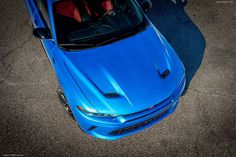 a blue sports car is parked on the street