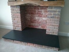 a brick fireplace with a shelf above it