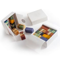 several different colored soaps in white boxes