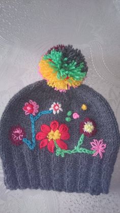 a knitted hat with flowers on it