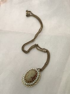 "Small costume jewelry faux cameo necklace. Center cameo surrounded by faux pearls on a gold filled chain . Could be a necklace for a child or a child in a wedding party, or prop in a costume shop. Measurements are; 16 1/2\" from end to end. Feel free to convo me with any further questions. Thank you for your interest.l" Vintage Cameo Jewelry For Party, Cameo Costume Jewelry Necklace As Gift, Cameo Costume Jewelry Necklace For Gift, Victorian Cameo Jewelry For Party, Gold Cameo Jewelry For Party, Victorian Pearl Chain Necklace As Gift, Jewelry Faux, Beauty Spot, Salty Dog