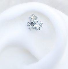 a diamond ring sitting on top of a white surface