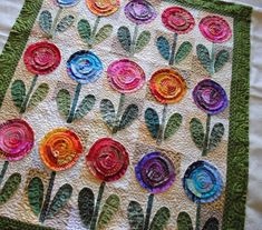 a close up of a quilt with flowers on it