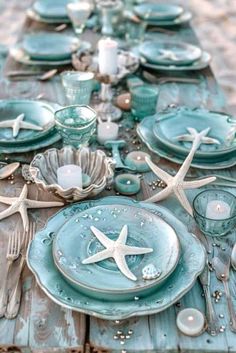 the table is set with starfish and seashells for an ocean themed dinner