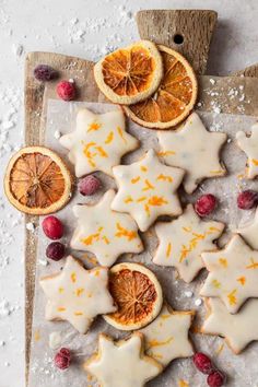 orange slices and star shaped cookies on a cutting board