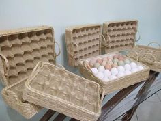 three baskets filled with eggs sitting on top of a table