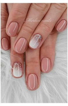 french manies with white and gold glitters on the tips, one nail has been painted