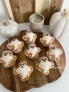 cupcakes with frosting and spooky eyes on a wooden board