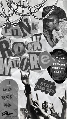 black and white photograph of people holding their hands up in the air with various stickers on them