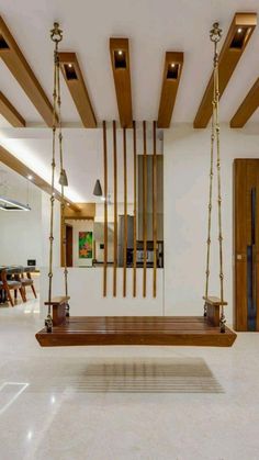 a wooden swing in the middle of a room