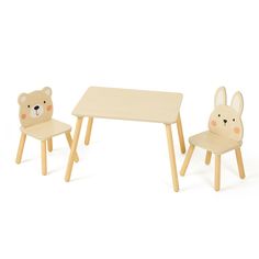 a wooden table with two chairs and a teddy bear