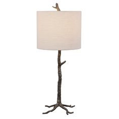 a lamp that is on top of a metal stand with a bird perched on it