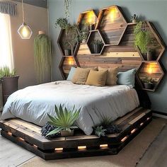 a bed made out of pallet wood with plants on the headboard and shelves above it