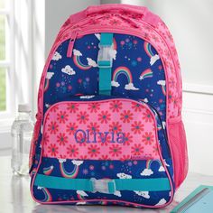 "Make a big and sassy entrance at school with our Rainbow Print Personalized Backpack by Stephen Joseph. Our super comfortable kids backpack is designed to securely hold anything you need! - Embroidered with any name in your choice of font and thread color - Each item sold separately - Features cushioned adjustable shoulder straps with a top carrying handle - Includes two mesh exterior side pockets and two outside hook-on straps - Three interior storage compartments; main compartment includes an Embroider Backpack, Street Backpack, Kids Backpack Boys, Personalized Backpack Kids, Personalization Mall, Embroidered Backpack, Personalized Memorial Gifts, Custom Backpack, Pink Color Schemes