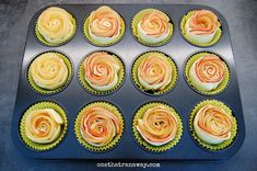 cupcakes with orange and yellow frosting in a muffin tin