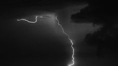 a black and white photo of lightning in the sky