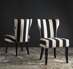 two black and white striped chairs sitting next to each other on a carpeted floor