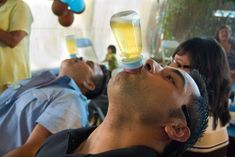 a man laying on the ground with his mouth open and an inhaler attached to his head