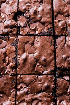 brownies with chocolate frosting on top are arranged in square rows and placed next to each other